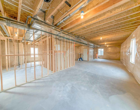 Can I frame basement walls over slab cracks?